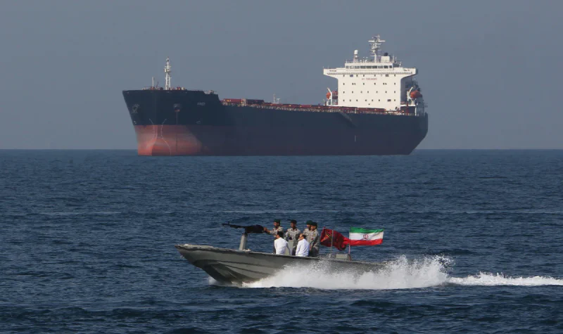 Oil tanker and patrol boat at the Strait of Hormuz