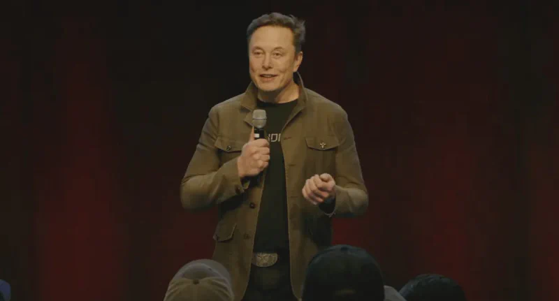 Elon Musk speaking at a Tesla event